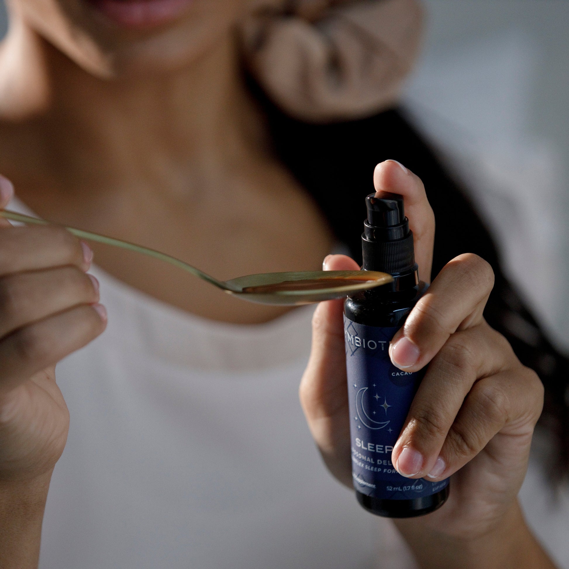 Woman Pumping Liposomal Sleep Onto a Spoon